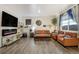 Inviting living room features a fireplace, stylish shelving, hardwood floors, and plenty of natural light at 2303 Monte Vista St, Fort Lupton, CO 80621