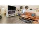 Spacious living room featuring a modern fireplace, hardwood floors, and plenty of space for entertaining at 2303 Monte Vista St, Fort Lupton, CO 80621