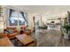 Open-concept living room with hardwood floors seamlessly connects to the dining area and kitchen at 2303 Monte Vista St, Fort Lupton, CO 80621