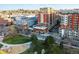 An aerial view of the neighborhood showcasing nearby green spaces, high-rise buildings, and city streets at 1950 N Logan St # 1109, Denver, CO 80203