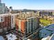 Scenic aerial view showcases a modern condo building in the city with stunning skyline views at 1950 N Logan St # 1109, Denver, CO 80203