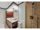 Modern bathroom featuring dual sinks, vanity with dark wood cabinets, and stone-lined shower at 1950 N Logan St # 1109, Denver, CO 80203