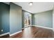 Bright bedroom features a balcony with city views and hardwood floors for a comfortable living space at 1950 N Logan St # 1109, Denver, CO 80203