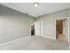 Cozy bedroom with neutral carpet, light gray walls, and access to the kitchen and bathroom at 1950 N Logan St # 1109, Denver, CO 80203