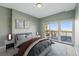 Comfortable bedroom with private balcony access and soft, neutral decor and city views at 1950 N Logan St # 1109, Denver, CO 80203