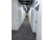 A long, carpeted hallway with block-wall construction leading to residences at 1950 N Logan St # 1109, Denver, CO 80203