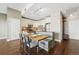 Modern kitchen with white cabinets, stainless steel appliances, breakfast bar seating, and a tiled backsplash at 1950 N Logan St # 1109, Denver, CO 80203