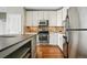 Updated kitchen with white cabinets, stainless appliances, breakfast bar and decorative tile backsplash at 1950 N Logan St # 1109, Denver, CO 80203