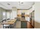 Bright kitchen with white cabinetry, stainless steel appliances, breakfast bar seating, and hardwood floors at 1950 N Logan St # 1109, Denver, CO 80203