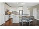 Modern kitchen features white cabinets, stainless steel appliances, and a dining area with built-in seating at 1950 N Logan St # 1109, Denver, CO 80203
