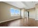 Open living room featuring hardwood floors, neutral paint, a large window, and ample natural light at 1950 N Logan St # 1109, Denver, CO 80203