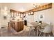 Charming kitchen features wooden cabinets, a dining table, and a breakfast bar for a cozy dining experience at 5995 W Hampden Ave # 8C, Denver, CO 80227