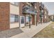 Apartment complex entrance featuring brick facade, private balconies and well-maintained grounds at 5995 W Hampden Ave # 8C, Denver, CO 80227