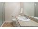 Bathroom featuring tile floors, granite countertop, large mirror, and a walk in shower at 3762 White Rose Loop, Castle Rock, CO 80108