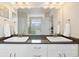 Bright bathroom featuring dual sinks, a large mirror, and ample countertop space at 3762 White Rose Loop, Castle Rock, CO 80108