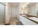 This bathroom features double sinks, white cabinets, and an enclosed shower at 3762 White Rose Loop, Castle Rock, CO 80108