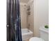 Bathroom with a shower over tub, tiled surround and a dark shower curtain at 3762 White Rose Loop, Castle Rock, CO 80108