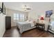 This bedroom features hardwood floors, an accent wall decor and a ceiling fan at 3762 White Rose Loop, Castle Rock, CO 80108