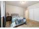 Carpeted bedroom featuring a large closet with sliding doors, and a comfortable queen sized bed at 3762 White Rose Loop, Castle Rock, CO 80108
