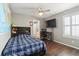 Cozy bedroom featuring hardwood floors, ceiling fan and a large window with nice window shutters at 3762 White Rose Loop, Castle Rock, CO 80108