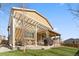 Tan two story home featuring a covered patio with a grill and an open patio with dining area at 3762 White Rose Loop, Castle Rock, CO 80108