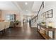 Inviting foyer with hardwood floors and staircase, showcasing an open concept design and stylish decor at 3762 White Rose Loop, Castle Rock, CO 80108
