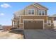Charming two-story home with a two-car garage and a well-maintained lawn on a sunny day at 3762 White Rose Loop, Castle Rock, CO 80108