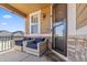 Inviting front porch featuring comfortable seating and stone accents, perfect for relaxation and curb appeal at 3762 White Rose Loop, Castle Rock, CO 80108