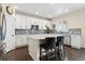 Bright kitchen with white cabinets, stainless steel appliances, and an island with bar seating at 3762 White Rose Loop, Castle Rock, CO 80108