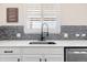 Stylish kitchen sink area with modern fixtures, granite countertops, and a contemporary backsplash at 3762 White Rose Loop, Castle Rock, CO 80108