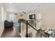 Open concept living room featuring dark hardwood floors and an ornate staircase at 3762 White Rose Loop, Castle Rock, CO 80108