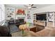 Comfortable living room showcases a stone fireplace, built-in bookshelves, and stylish decor at 3762 White Rose Loop, Castle Rock, CO 80108