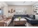 Bright living room featuring large windows, hardwood floors, and comfortable leather sofas at 3762 White Rose Loop, Castle Rock, CO 80108