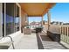 Covered patio featuring comfortable seating area, coffee table, and black outdoor storage container at 3762 White Rose Loop, Castle Rock, CO 80108