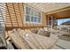Covered patio featuring a large dining table with seating, and additional outdoor seating area at 3762 White Rose Loop, Castle Rock, CO 80108