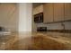 Granite countertops enhance this kitchen, equipped with stainless steel microwave and a stove at 720 16Th St # 513, Denver, CO 80202