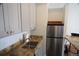 A modern kitchen with grey cabinets, stainless steel fridge and stone countertops at 720 16Th St # 513, Denver, CO 80202