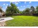 Wide shot of the spacious backyard with lush grass and wooden fence at 9054 Dover St, Westminster, CO 80021