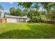 Large backyard featuring mature trees, lush green grass and a wood fence at 9054 Dover St, Westminster, CO 80021
