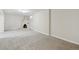 View of a large finished basement with a unique corner fireplace and neutral carpet at 9054 Dover St, Westminster, CO 80021