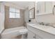 Bright bathroom featuring a shower and tub combination, tiled walls, and a white vanity at 9054 Dover St, Westminster, CO 80021