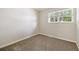 The empty bedroom has neutral carpet and large window at 9054 Dover St, Westminster, CO 80021