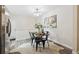 Open dining area featuring seating for four and decorative floral arrangement and a neutral color pallet at 9054 Dover St, Westminster, CO 80021