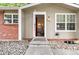 Inviting entryway with a decorative stone garden, a red front door, and windows that provide ample natural light at 9054 Dover St, Westminster, CO 80021