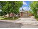 This single-Gathering home boasts a spacious driveway, a well-kept lawn, and a brick and siding exterior at 9054 Dover St, Westminster, CO 80021