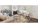 Bright living room with fireplace, light neutral furniture, large window, and decorative rug at 9054 Dover St, Westminster, CO 80021