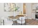 A dining area boasts a decorative painting, a modern chandelier, and a wooden dining table at 9054 Dover St, Westminster, CO 80021