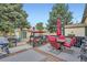 Inviting backyard deck with outdoor seating, a grill, and a charming swing, ideal for relaxation at 5704 Ammons St, Arvada, CO 80002