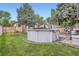 Spacious backyard featuring an above-ground pool, well-maintained lawn, and mature trees offers outdoor fun at 5704 Ammons St, Arvada, CO 80002