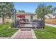 Charming backyard patio with a swing, grill, and lush greenery offers a cozy outdoor retreat at 5704 Ammons St, Arvada, CO 80002